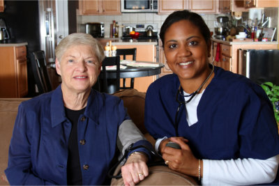 caregiver and elderly woman smiling